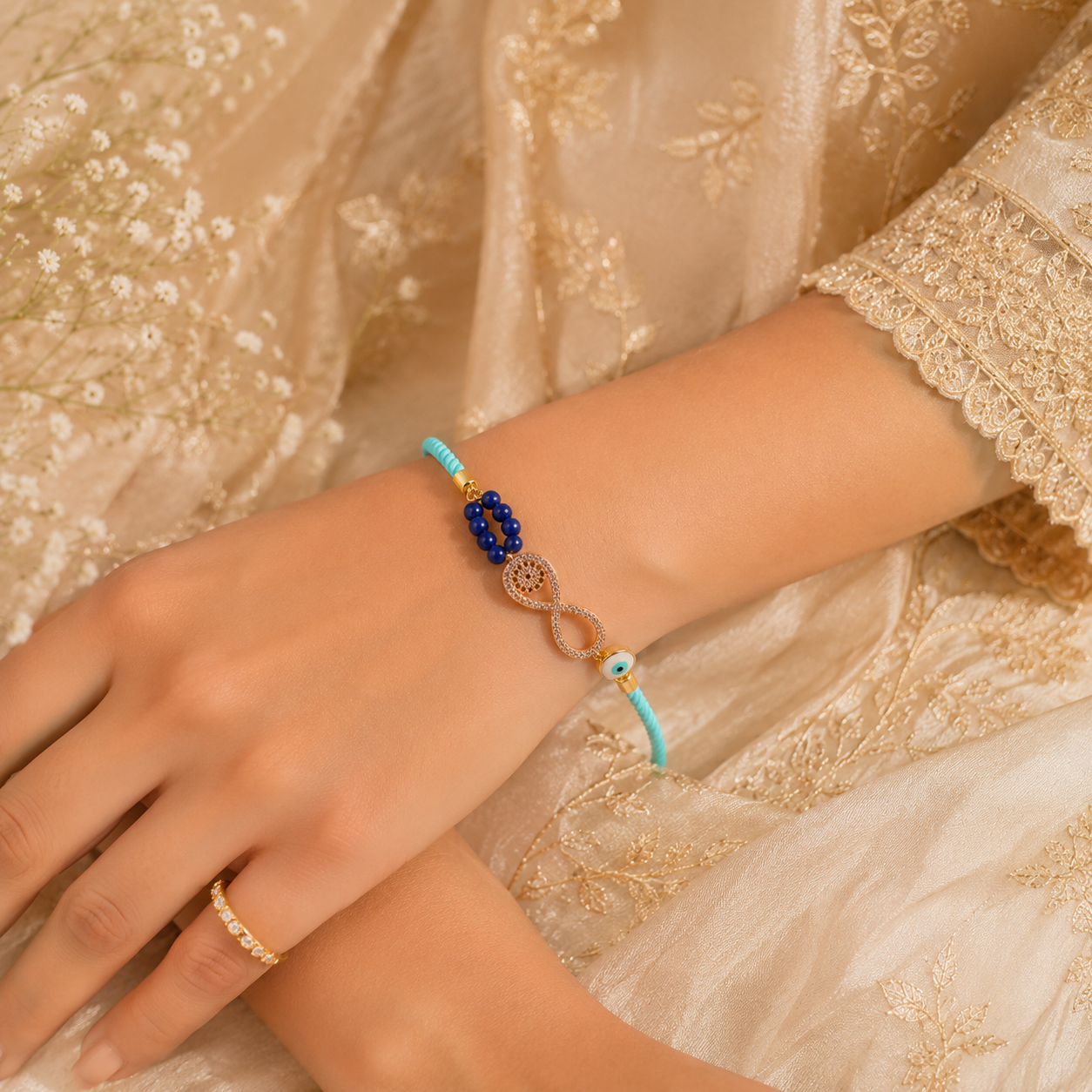 Infinity Evil Eye Lumba Rakhi with Blue Beads & Adjustable Sky Blue Thread