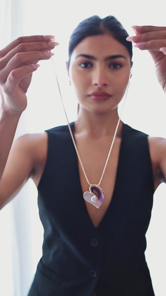 Blush pearl heart necklace and earrings worn by model