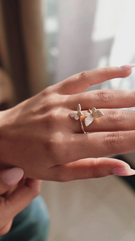 Golden twin butterflies ring on hand